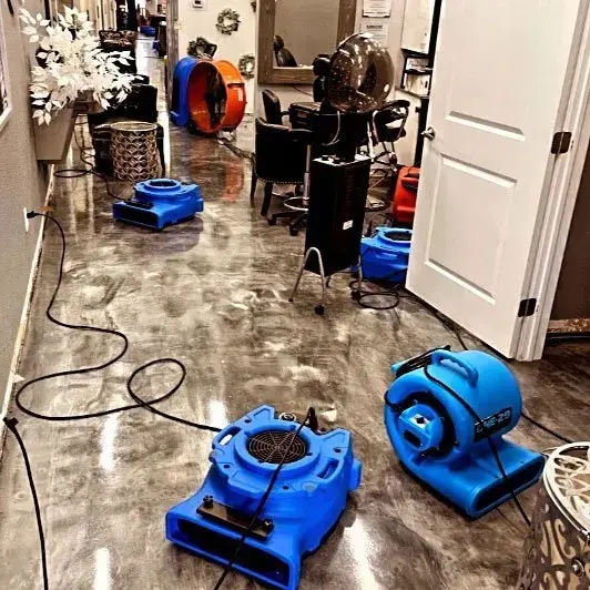 Air movers drying a wet floor and hallway after water damage in Lodi