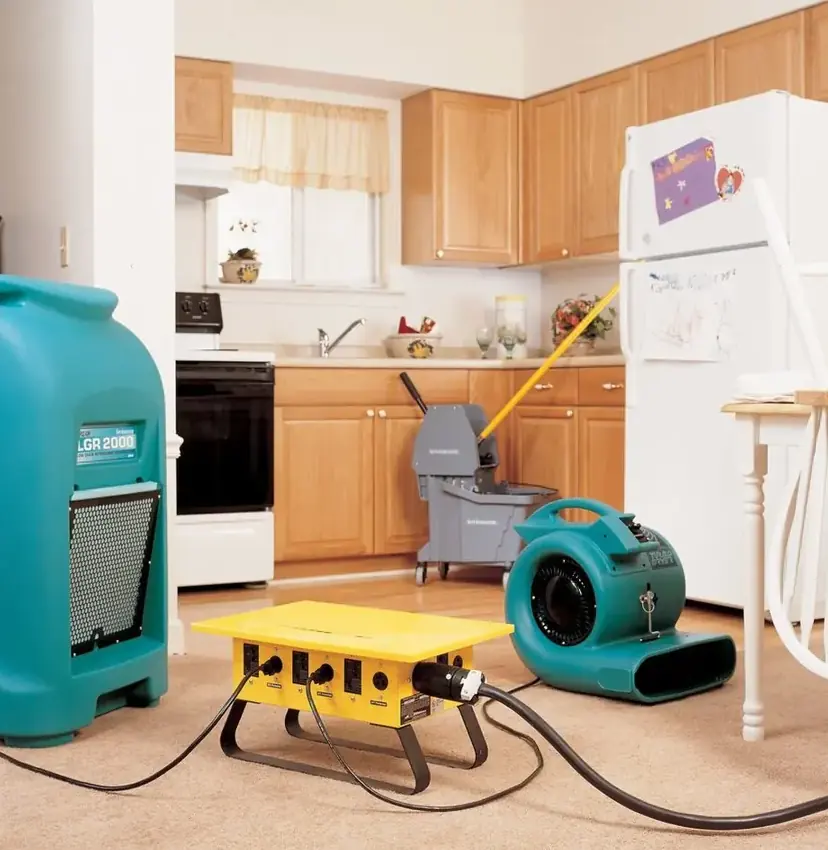 Dehumidifier and air mover drying a kitchen floor after water damage in Lodi