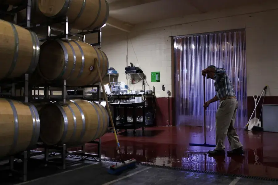 Water on the floor of a barrel room being cleaned at a Lodi winery