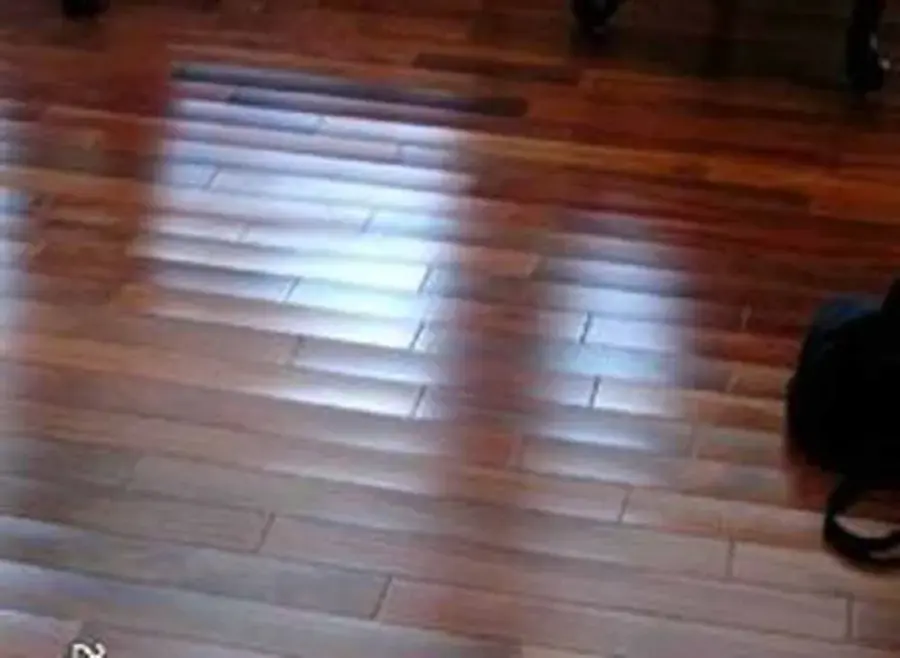 Wet hardwood floor boards after a water leak in a Lodi home